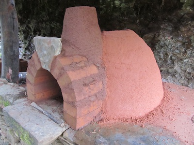 Insulation layer of cob oven being added