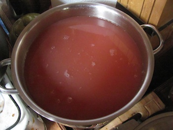 Strained quince cooking water before adding sugar