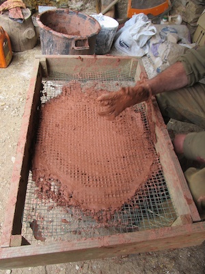 Sieving clay for earthen plaster